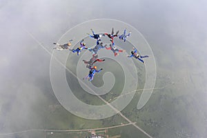 Formation skydiving in the white cloud.