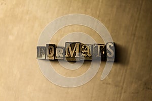 FORMATS - close-up of grungy vintage typeset word on metal backdrop