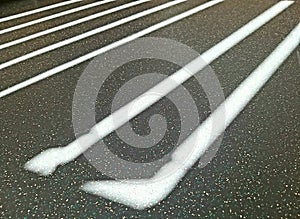 Formed light rays falling on a cement floor and small pebbles.