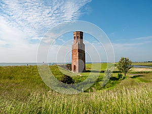 Former church tower Plompetoren on dike at Oosterschelde, Easter Scheldt, estuary, Zeeland, Netherlands