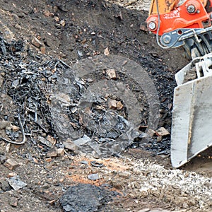 Former rubbish dump in the excavation pit, black discoloured and