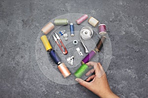 Forming a heart shape with a collection of thread spools and sewing tools