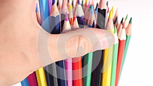 Forming a stack of colorful pencils