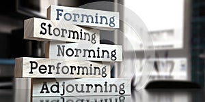 Forming, storming, norming, performing, adjourning - words on wooden blocks photo