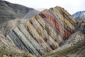 An anticline geological formation is a type of fold in rock layers that arches upward, creating a convex shape photo