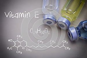 Formula Chemical Vitamin E together with different vials photo
