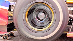 Formula one car wheel spinning while driver tests engine