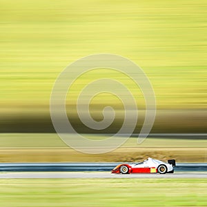 Formula one race car on speed track - motion blur background wit