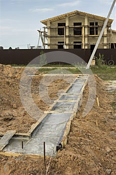 Formwork of the foundation of the future house is filled with concrete