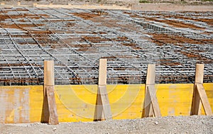 formwork made with yellow wooden planks during laying cement on the construction site