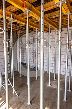 formwork - metal poles supporting the slabs on which concrete will be poured to make the ceiling in the building