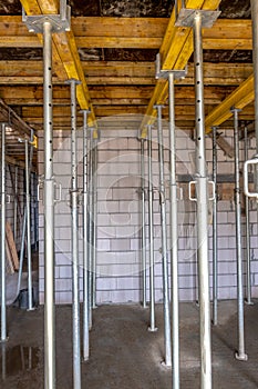 formwork - metal poles supporting the slabs on which concrete will be poured to make the ceiling in the building