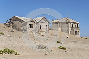 forsaken buildings on sand at mining ghost town in desert, Kolmanskop, Namibia