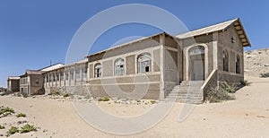 forsaken hospital buildings on sand at mining ghost town in desert, Kolmanskop, Namibia