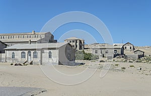 forsaken run-down buildings at mining ghost town in desert, Kolmanskop, Namibia