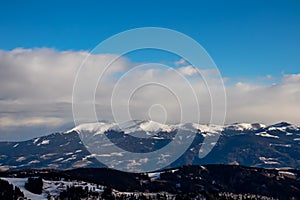 Forstalpe - Panoramic view of snow capped mountain peaks and hills of Packalpe, Carinthia Styria border