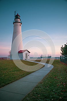 The Fort Gratiot lighthouse in Michigan with a freighter in the background