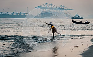 Fort Kochi fisherman throwing his net into the water india