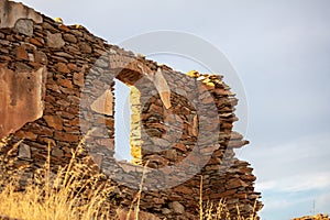 Fort ruins at Tzia, Kea island, Greece. Red stonewall of ancient castle background