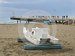Forte dei Marmi famous pier and patino traditional rowing boat photo