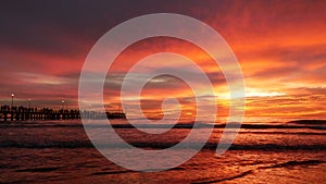 Forte dei Marmi: People admiring  a wonderful fiery sunset from the famous pier