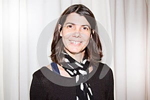 Forties brunette woman in black clothes smile at home