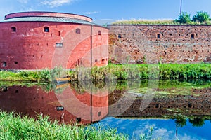Fortification walls of Malmo Castle reflecting in its moat, Swed
