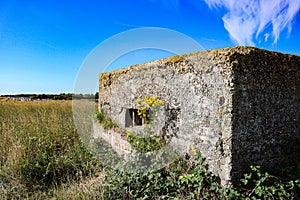 Fortified old wartime bunker on norfolk coastline england east anglia photo