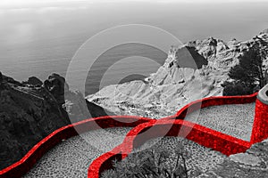 Fortified red wall of the medieval castle. Beautiful scenic view of the country house on the mountain and the blue sea. Panoramic