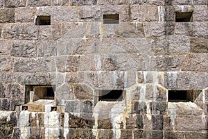 Fortified wall with embrasure in the wall photo
