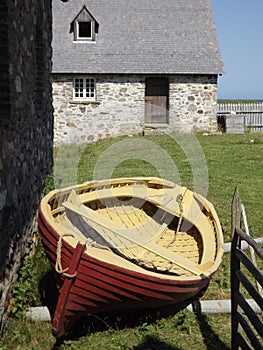 Fortress Louisbourg old boat and stone building photo