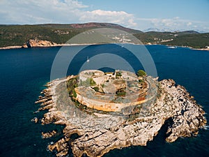 Fortress Mamula on the island against the backdrop of the mountains of Montenegro