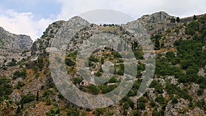 Fortress on mountaines. View from Kotor city Montenegro. Big stone wall and chapel above.