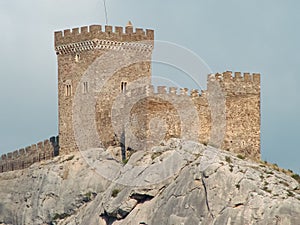 A fortress in the Romanesque style of the time of the knights, which stands on the edge of a stone cliff.