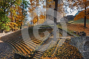 Fortress ruins and ancient steps covered by yellow autumn leaves