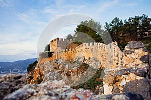 Fortress wall of the Alanya castle in the Old Town. Crenelated walls Alanya Kalesi. Selective focus