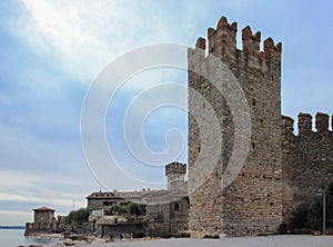 Fortress wall with a corner tower and promenade in front of the Scaliger Castle