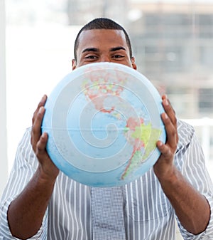 Fortunate businessman holding a terrestrial globe