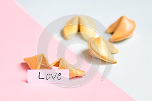 fortune cookie on pink and blue background, pastel colors, love prediction