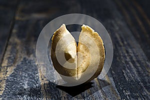 Fortune Cookie on wooden boards with a piece of hope paper inside