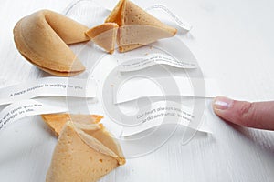 Fortune cookies in hands with advices, motivation mottos and blank space for copy. photo