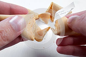 Fortune cookies in hands with advices, motivation mottos and blank space for copy. photo