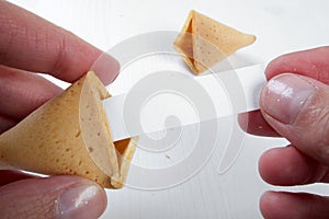 Fortune cookies in hands with advices, motivation mottos and blank space for copy. photo