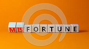 Fortune or misfortune symbol. Turned wooden cubes and changed the concept word misfortune to fortune. Beautiful orange table,