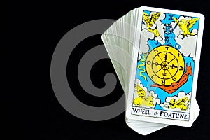 Fortune Tarot card on black background. Ancient symbols are used for divination