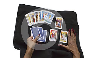 Fortune teller forecasting the future with tarot cards on black