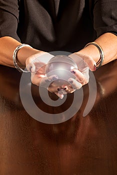 Fortune teller holding a glowing glass sphere