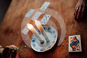 A fortune teller predicts the fate and future of a girl on tarot cards