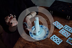 A fortune teller predicts the fate and future of a girl on tarot cards