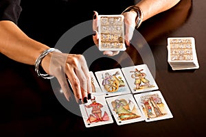 Fortune teller reading a deck of Tarot Cards